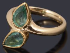 An 18ct gold two stone emerald crossover ring,