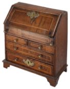 A 19th century George II style miniature walnut and oak bureau