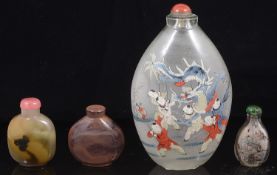 A large early 20th century Chinese inside painted glass snuff bottle and three others