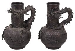 A pair of Japanese Meiji period bronze dragon vases