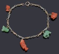 A two colour gold fancy link charm chain with assorted green hard stone and coral charms