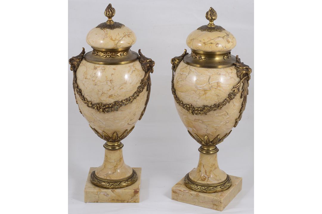 A pair of late 19th century French Louis XVI style ormolu mounted marble urns and covers