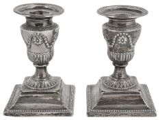 A pair of late Victorian silver neo-classical design Adam style dwarf candlesticks