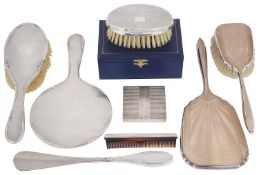 A mixed lot of silver to include dressing table sets, a compact and a boxed clothes brush and comb