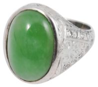A white gold single stone jade cabochon and diamond ring