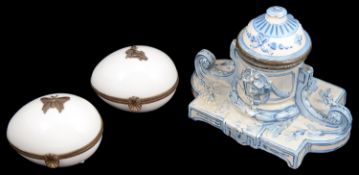 A 19th century continental faience inkwell and two Limoges egg shaped porcelain trinket boxes