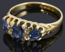 An early Edwardian 18ct gold sapphire and diamond three stone ring