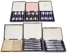 Six early 20th century cased sets of six silver coffee spoons and silver handled tea knives