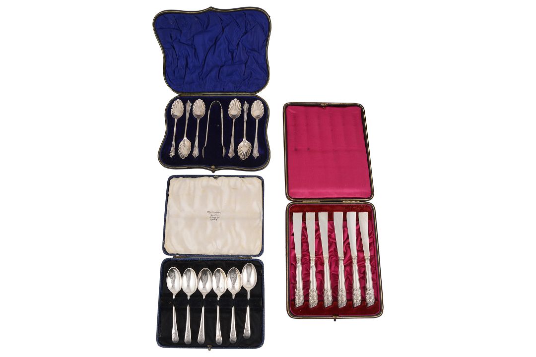 Two sets of six silver coffee spoons and a set of six silver handled tea knives