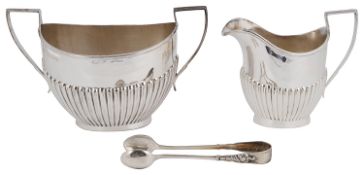 An Edwardian silver twin handled sugar bowl and milk jug