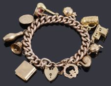 A 9ct gold hollow curb link bracelet with padlock and twelve assorted charms