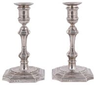 A pair of George V silver candlesticks in George I style