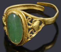 A high carat gold single stone green cabochon ring,
