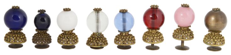 A collection of eight 19th century Qing dynasty Mandarin gilt metal and Peking glass hat buttons