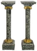 A pair of 19th century French style ormolu mounted green marble columns