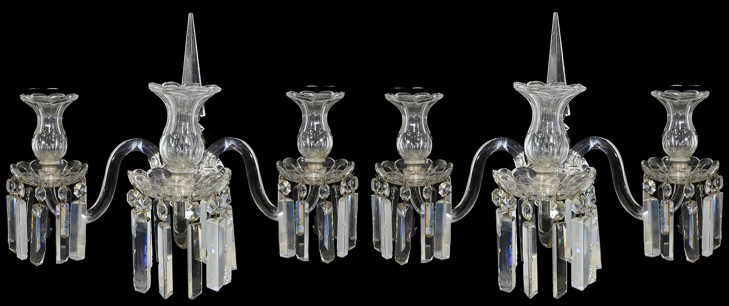 A pair of late Regency cut glass three light wall appliques in the manner of Osler