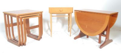 A 20th Century retro vintage teak nest by Parker Knoll raised on shaped supports. Together with a