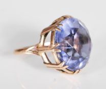A stamped 9ct gold ladies dress ring set with a large round faceted purple stone. Weight 11.5g. Size
