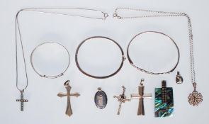A selection of silver jewellery to include a celtic knot design bangle, a hinged bangle channel