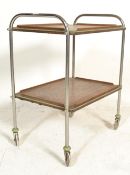 A vintage mid 20th Century retro two tier tea trolley having a chromed tubular frame with two
