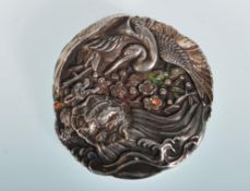 An early 20th Century Chinese silver and enamel brooch, the brooch decorated in relief with a Crane,