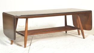 A 20th century Ercol beech and elm extending coffee table, rectangular top with two drop leaves