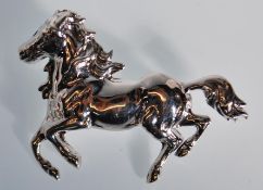 A silver brooch in the form of a galloping horse having a roller clasp. Stamped sterling to verso.