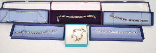 A collection of six silver bracelets and necklaces to include four 925 silver curb link style