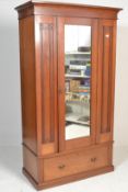 A good Edwardian walnut single wardrobe being raised on a plinth base with deep drawer. Above, a