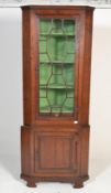 A 19th century mahogany freestanding corner cupboard, the moulded top above a glazed door
