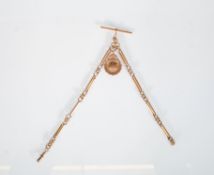 An early 20th Century 9ct gold pocket watch fob chain having a bar link chain having a round fob