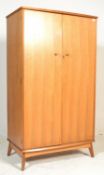 A Gordon Russell type mid century walnut double wardrobe. Raised on angled legs with upright body