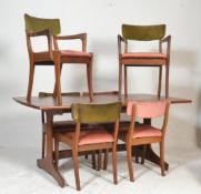 A good retro 20th Century teak wood extending dining table raised on splayed legs with extending