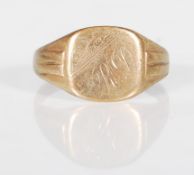 An English hallmarked 9ct yellow gold signet ring having a cushion shaped head with engraved