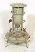 A vintage retro 20th Century metal paraffin heater by Aladdin of cylindrical form raised on a