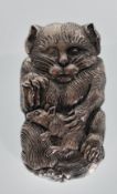 A silverplate vesta case in the form of a cat holding a rat having match striker to verso.