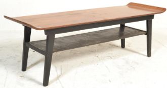 A 20th Century retro teak wood surfboard coffee table, shaped top raised on tapering ebonised