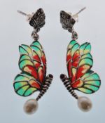 A pair of silver and marcasite earrings in the form of butterflies having plique a jour wings and