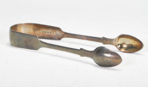 A pair of silver hallmarked sugar tongs being London hallmarked with Queen Victorian silhouette.