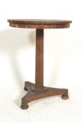 A Regency 19th century rosewood wine table being raised on a tripod base with bun feet having