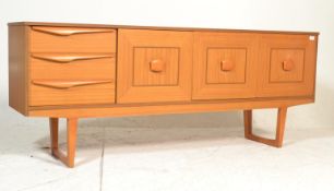 An original retro vintage mid-century teak wood sideboard credenza. Raised on squared legs with