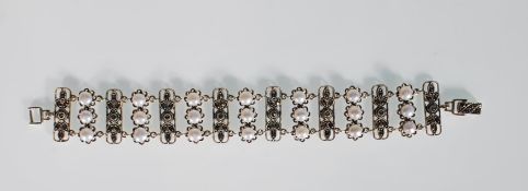 A decorative silver and marcasite bracelet having floral moulded panels interspersed with rows of