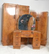 A 1930's Art Deco walnut bedroom suite comprising a drop centre walnut dressing table with good