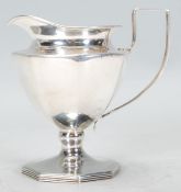 An early 20th century Edwardian silver hallmarked Cohen and Charles creamer jug of faceted