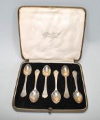 A cased set of of silver hallmarked coffee spoons having shaped handles with rat tail detailing to