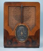 A 1930's Art Deco walnut two tone 4 valve radio. Of upright form having decorative walnut two tone