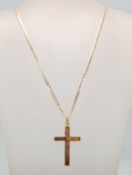 A lage 9ct gold hallmarked crucifix cross pendant set to a 9ct gold curb link necklace. Weighing 6.