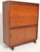 A 1970's retro vintage teak wood bureau having a drop down door top above a twin sliding door