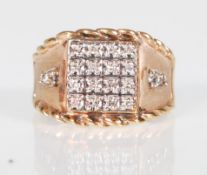 An English hallmarked 9ct gold ring having a square head set with 16 round cut diamonds having a