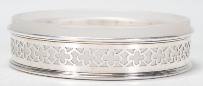 An early 20th Century 1930's Barker Brothers silver hallmarked wine coaster having pierced